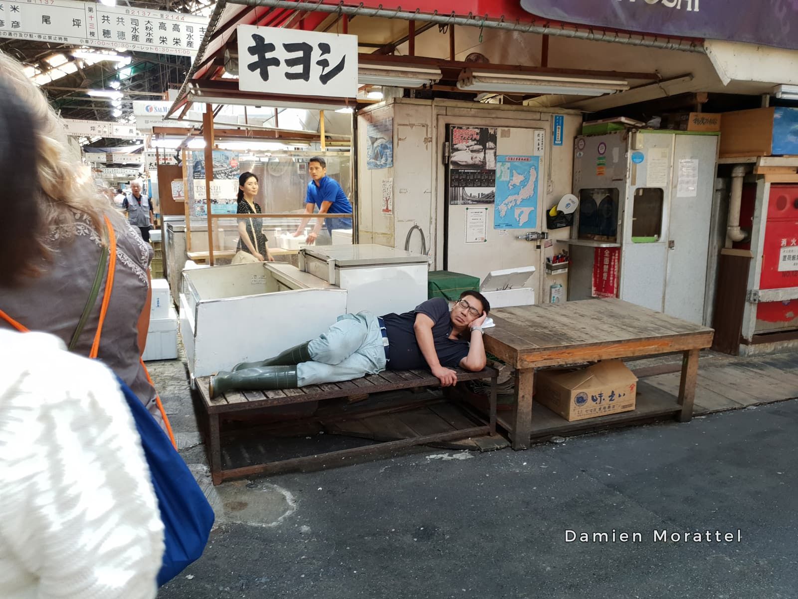 A man napping in his market stall