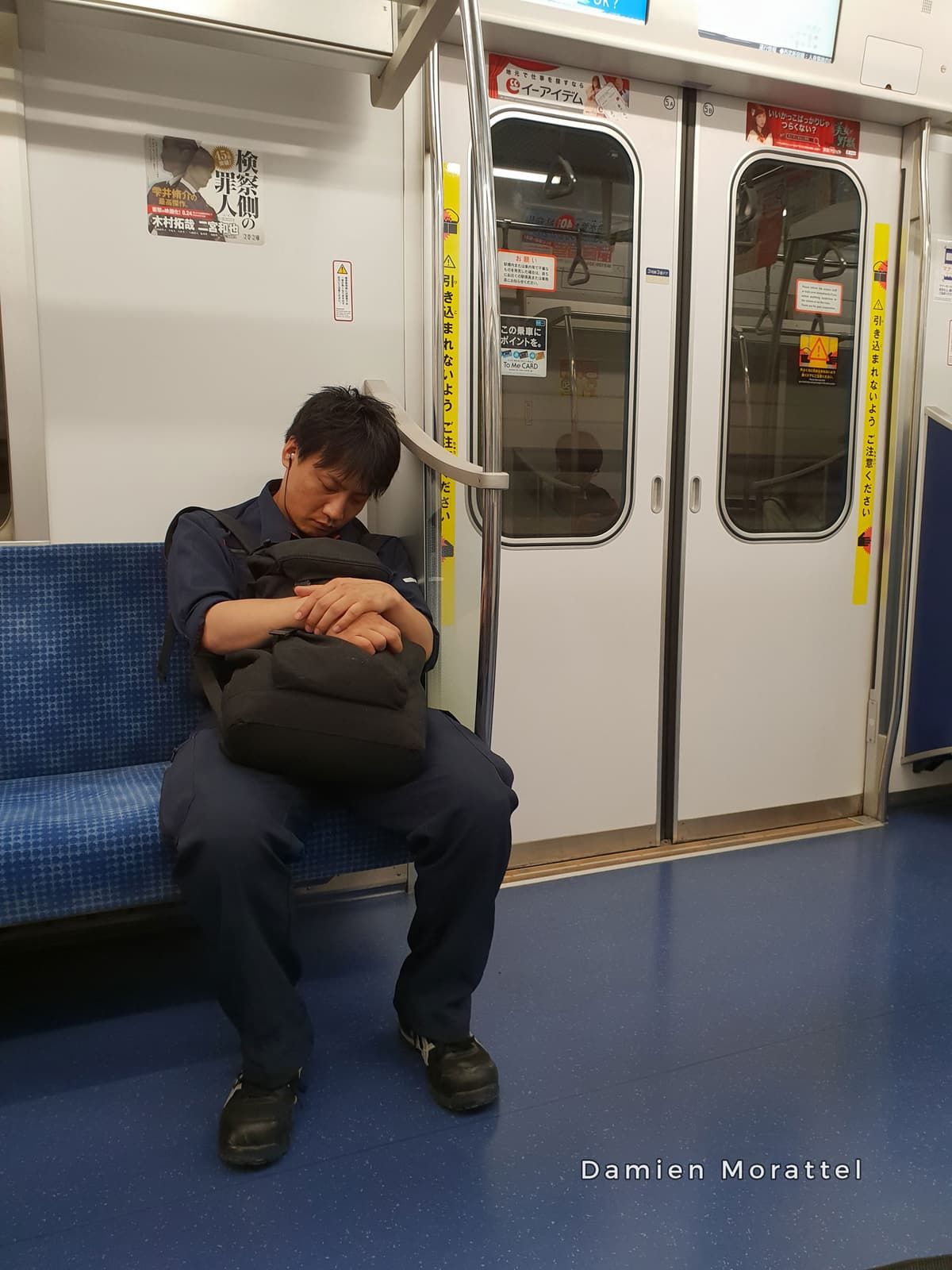 A passenger asleep on a train seat